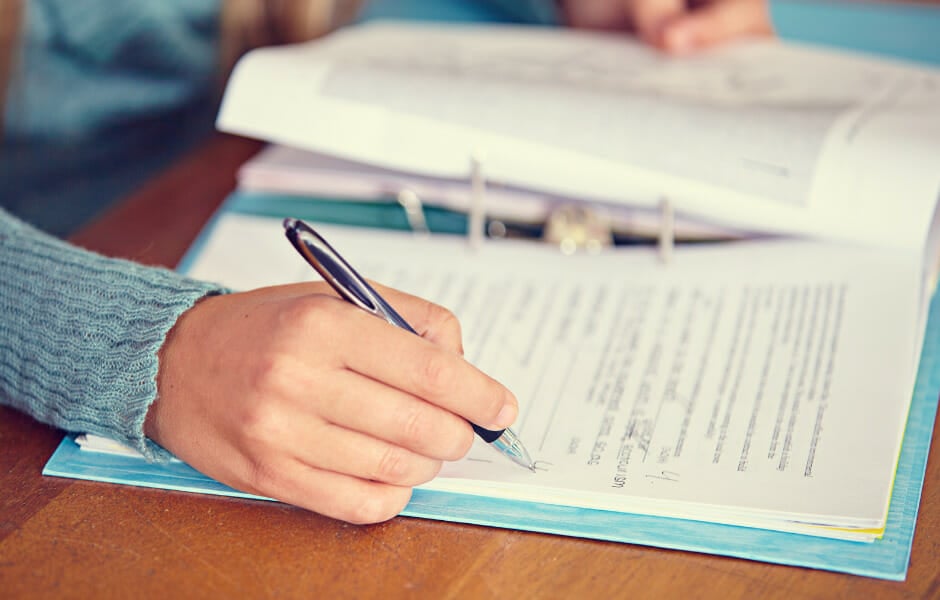 disc-assessments-types-an-individual-taking-notes-with-a-pen-and-spiral-bind-book