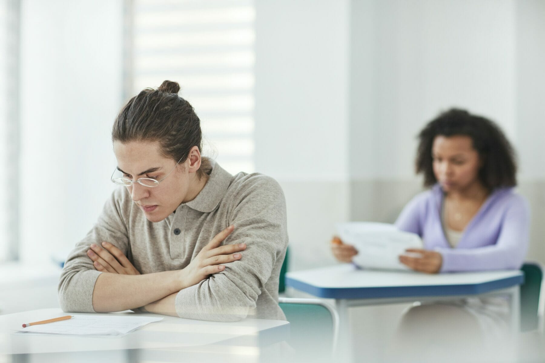 disc-personality-profile-two-individuals-sitting-on-seperate-desks-during-an-examination
